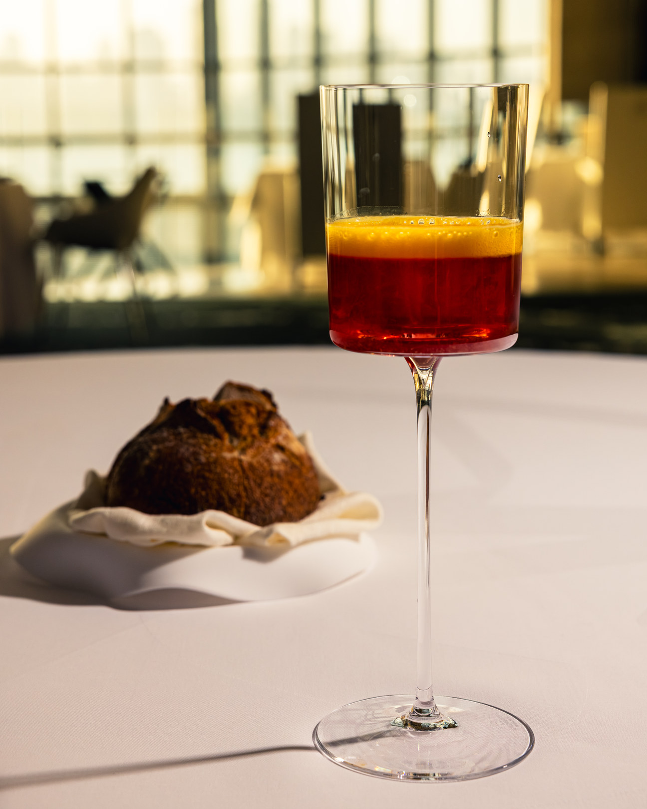 A layered zero-alcohol pairing beside a plated course by award-winning mocktail mixologist Robi Ratan at IDAM by Alain Ducasse in Doha