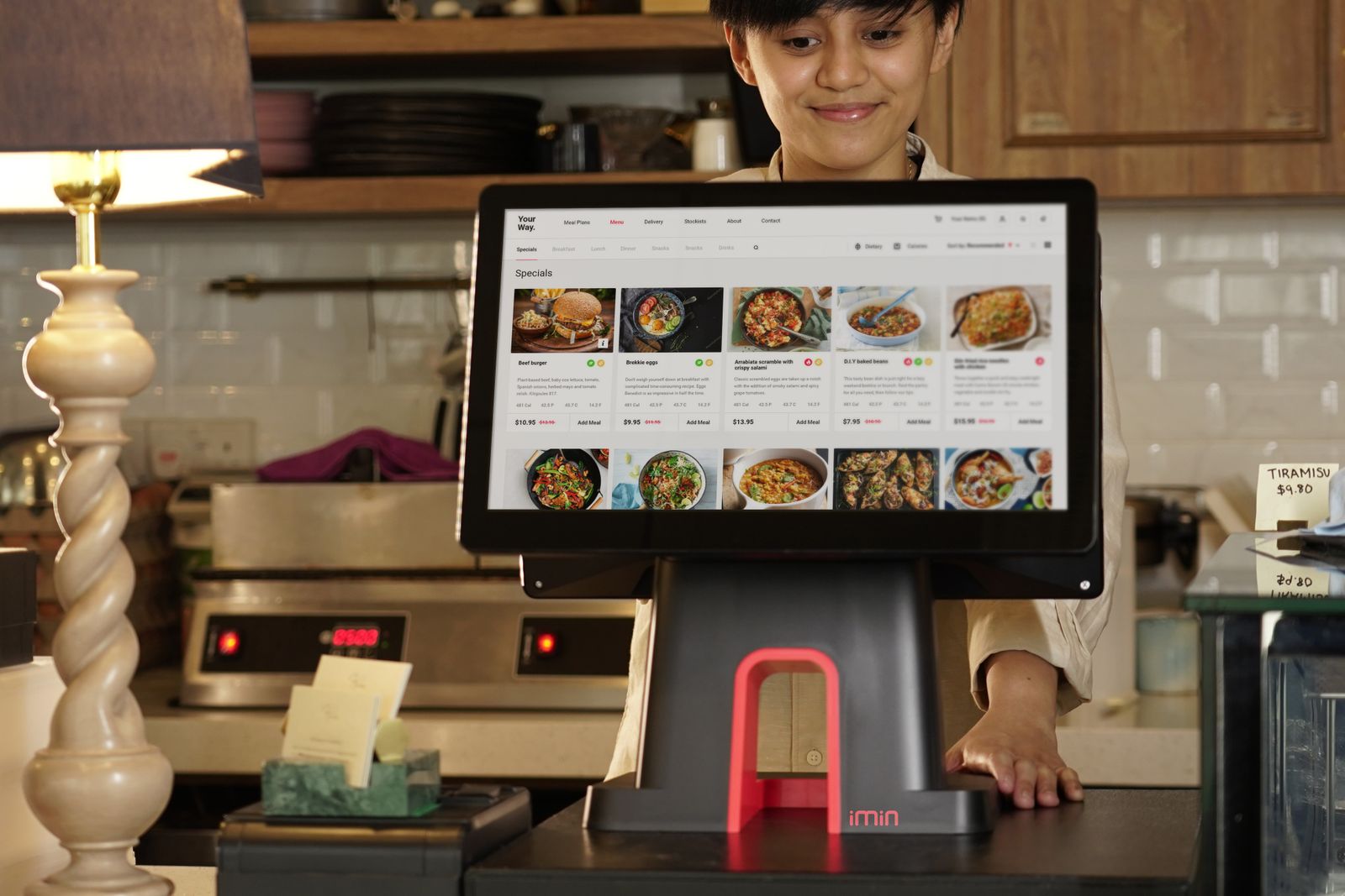 Restaurant employee using a touchscreen ordering and management system