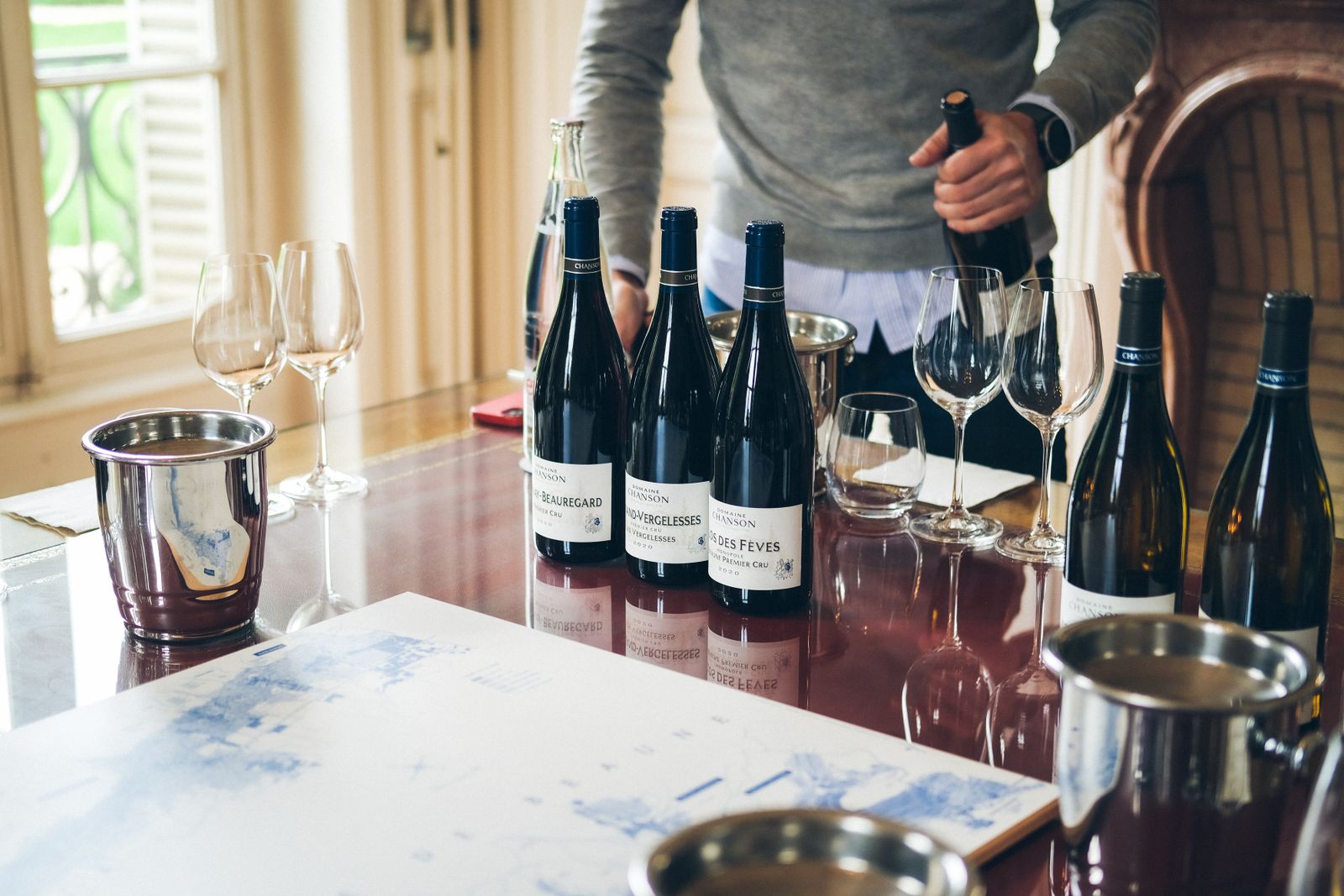 Sommelier pouring wine into glasses during restaurant service