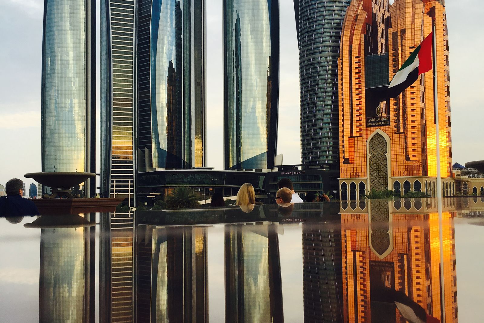 Abu Dhabi skyline and modern towers reflected at dusk
