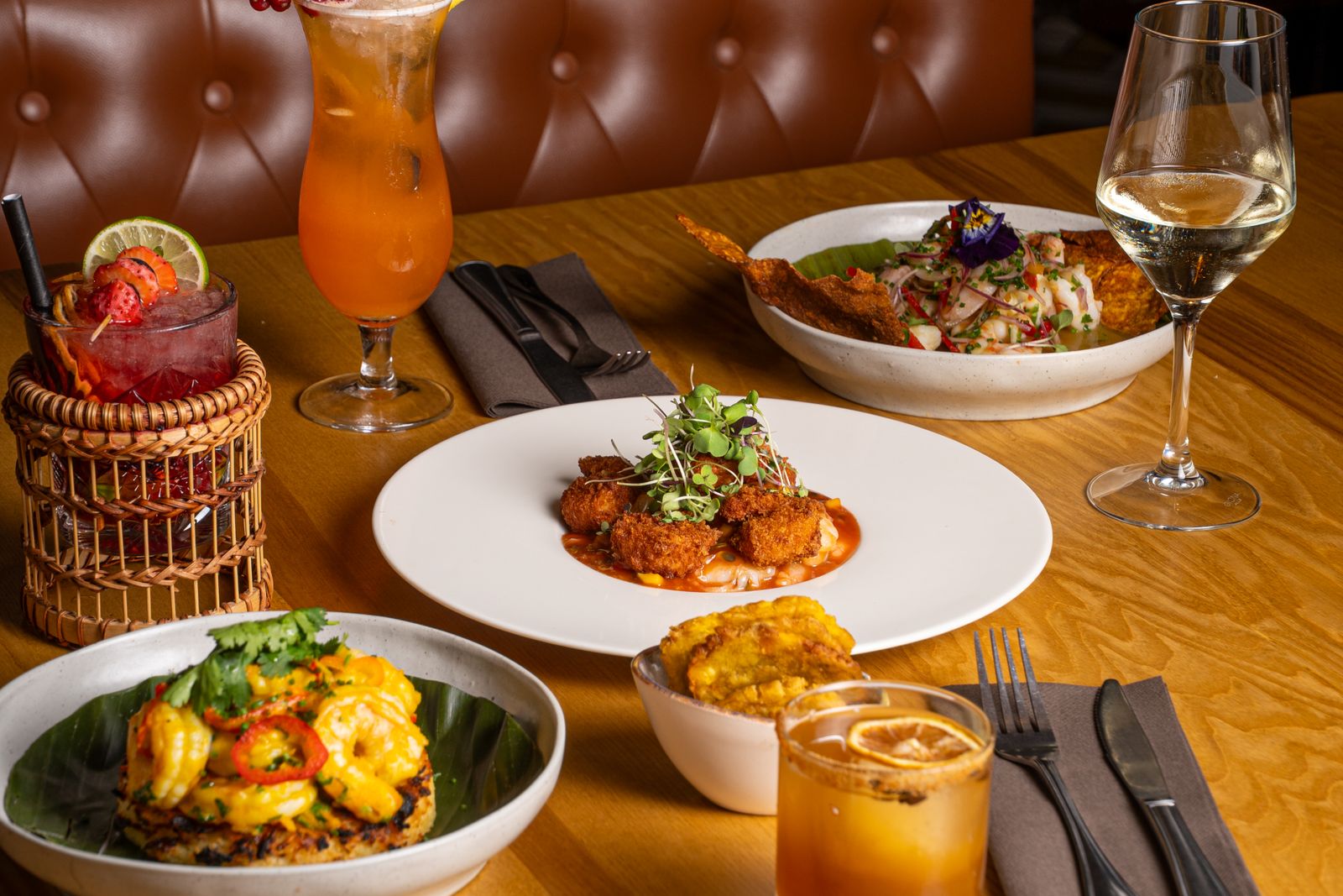 Gourmet dishes presented with cocktails on a restaurant table