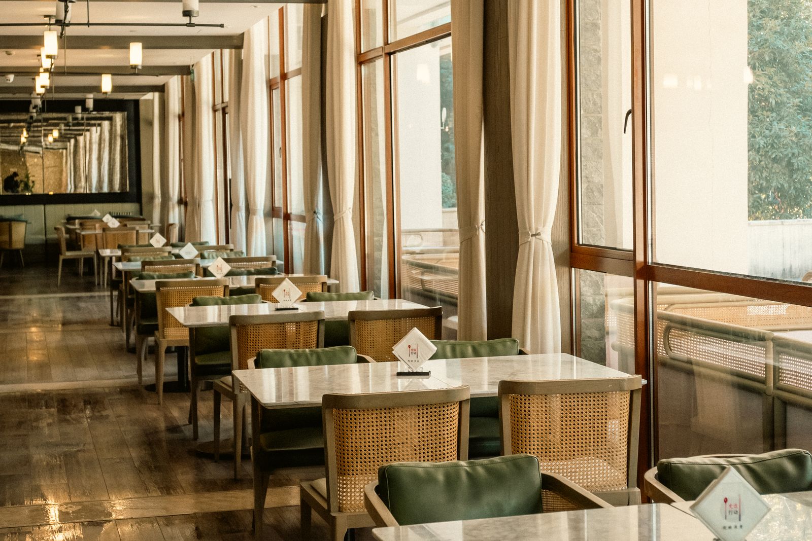 Spacious hotel dining room with natural light and contemporary furnishings