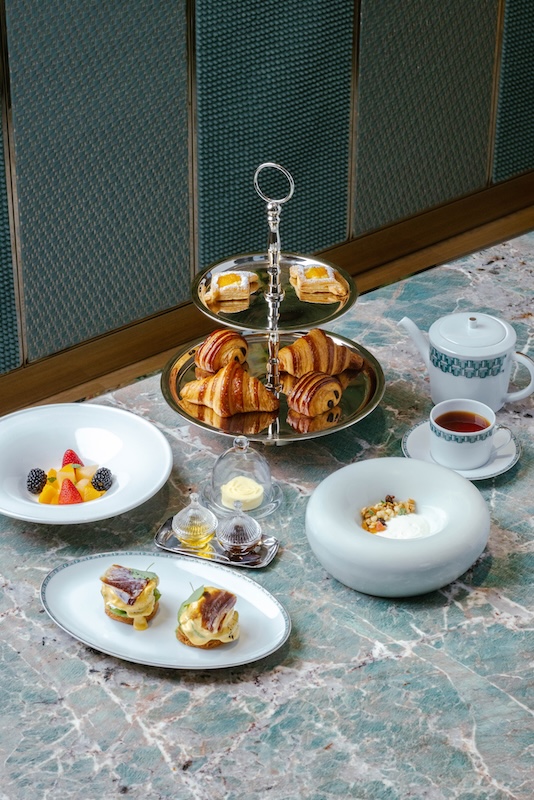 Breakfast at TiffanyxE2x80x99s spread with viennoiserie, fruit, yoghurt and tea service.