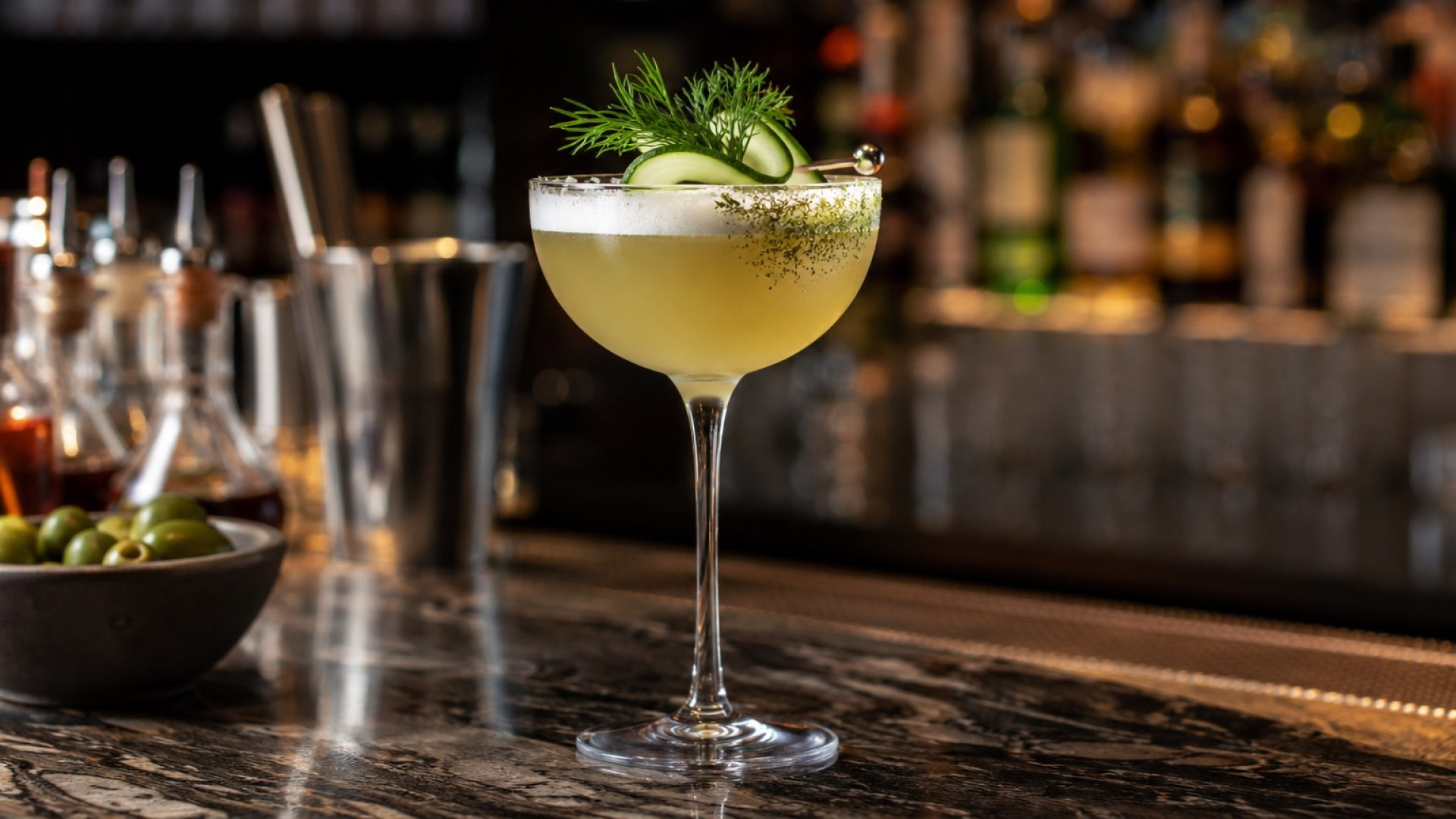Savoury cocktail with cucumber and dill garnish at a modern luxury bar