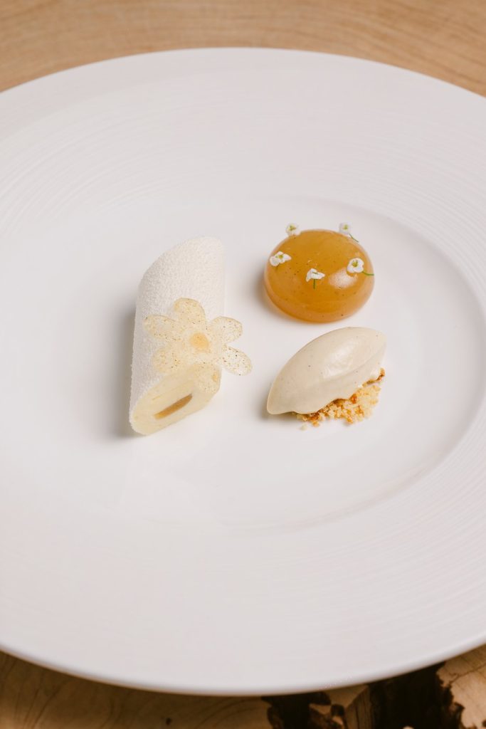 A pear dessert on a white plate at Àclèaf.